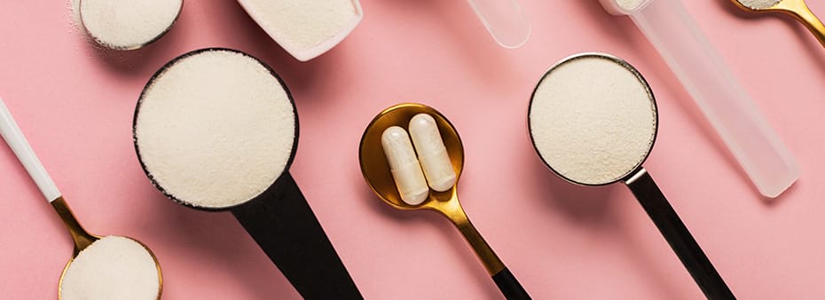 Collagen powder and pills in spoons